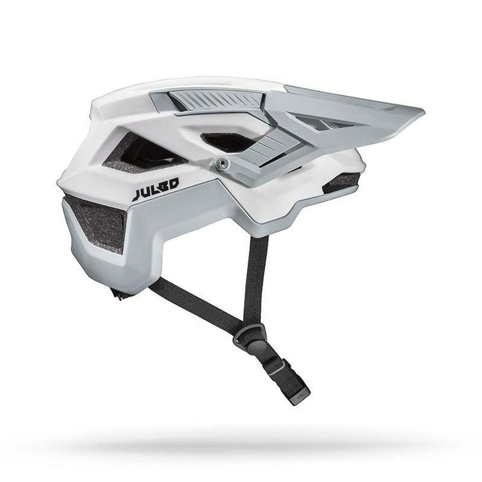 The Julbo USA Forest is a white and gray mountain bike helmet with an angular design, adjustable fit strap, MIPS protection, and a visor, shown in profile against a white background.