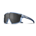 The Julbo-usa Fury Mini Kids sunglasses feature a translucent blue frame, large dark wraparound lenses with SPECTRON printed on them, and a logo on the temple—perfect for kids on the pump track. #color_translucent-blue-matte-blue-with-spectron-3-lens