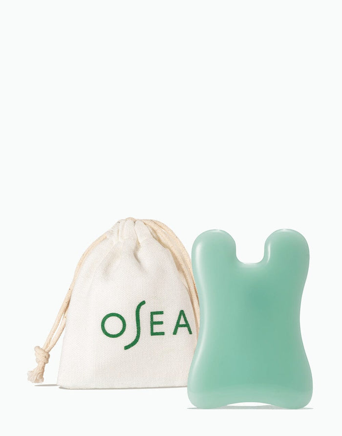 OSEA sculpting tool displayed next to branded drawstring pouch