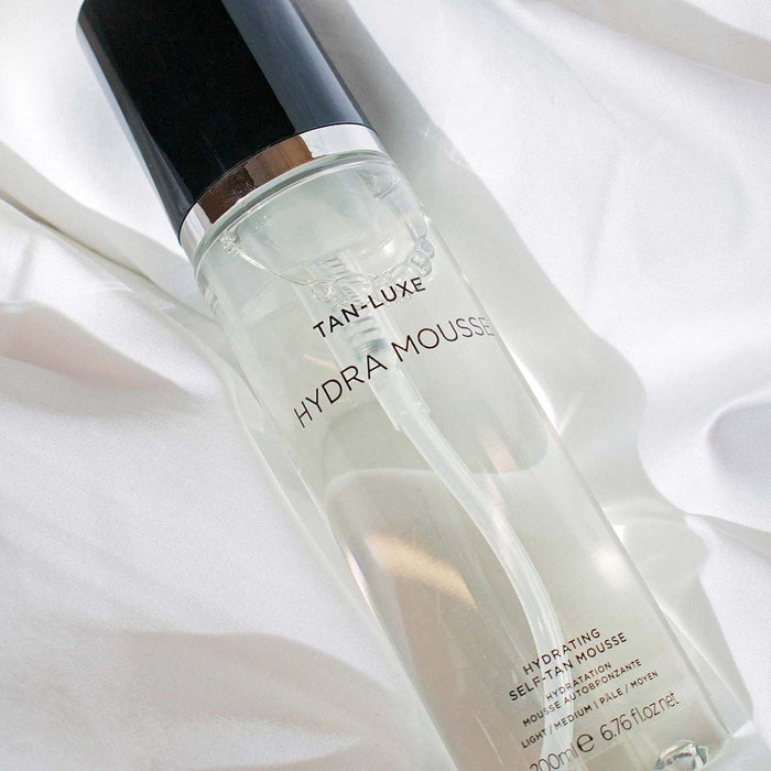 Lifestyle image of Tan-Luxe Hydra-Mousse Hydrating Self Tan Mousse variant: Light/Medium