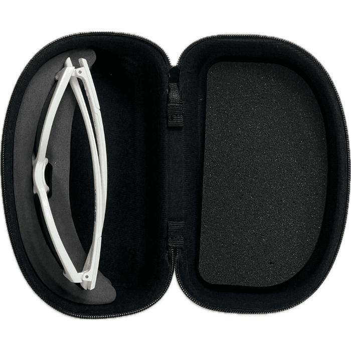 An open Julbo Eyewear Premium Hard Case with a soft black interior securely holds folded white sunglasses, offering reliable protection.