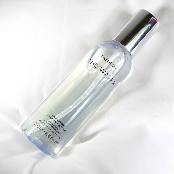 Lifestyle image of Tan-Luxe The Water Hydrating Self Tan Water variant: Light/Medium - 6.76 oz