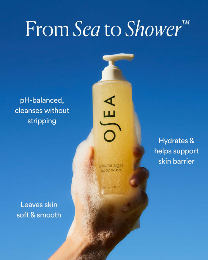 Undaria Algae Body Wash held with foam against blue sky with text highlighting pH-balanced cleansing and hydration