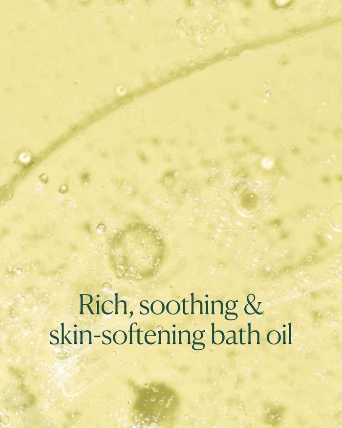 Close-up of milky bath oil texture in water with text emphasizing rich, soothing, skin-softening formula