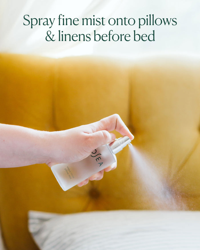 Hand spraying Vagus Nerve Pillow Mist onto pillow before bed