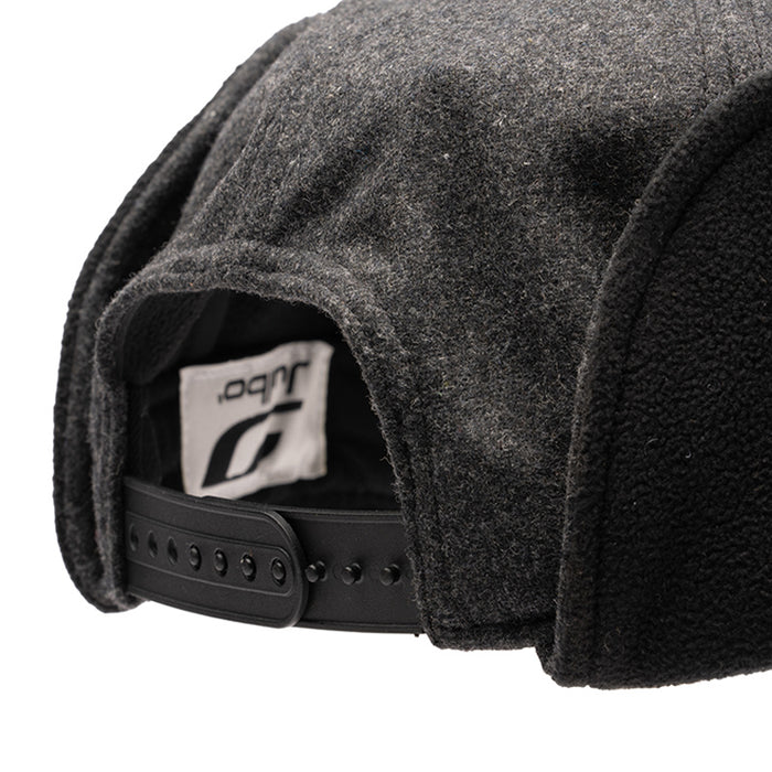 Close-up of the back of a grey and black snapback, designed for cold weather. Features an adjustable strap and white tag. Pairs perfectly with your favorite Julbo Eyewear Woodsman Hat or any earflap hat. #color_julbo-woodsman-hat-charcoal