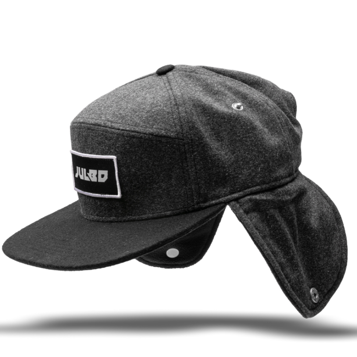 Keep warm in cold weather with the Julbo Eyewear Woodsman Hat—this dark gray hat has a black brim, long ear and neck flaps, and a JULBO logo patch on the front. #color_julbo-woodsman-hat-charcoal